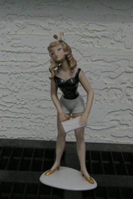 Crown above V above W Germany on cute lady in shorts figurine Crown above V above W Germany on cute lady in shorts figurine