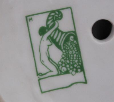 1920's style green figurine mark query of girl pouring a cornucopia full of pearls.