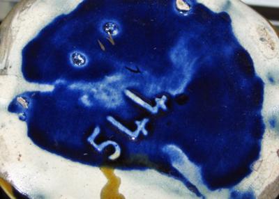 544 or 5LL marked  on base of two handled ornate vase/urn with painted panel of angel on a swing on blue ground