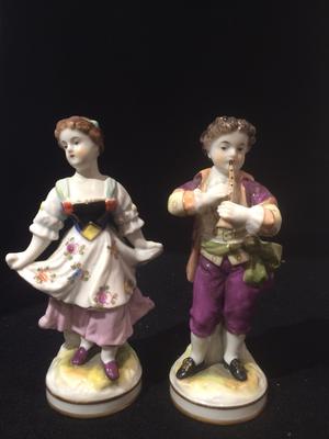 A Pair of Boy Girl Figurines with a 3 loops crown mark with a cross on top and two Gs one a backtofront mirror G