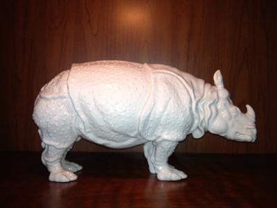 Side View - Blue Crown pottery mark above Initials TC or JC on white ceramic rhino - is this Tiffany?