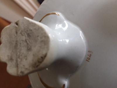 close up of 3 footed teapot