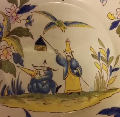 Flower with two leaves and three stripes marking on what looks like an Oriental plate please