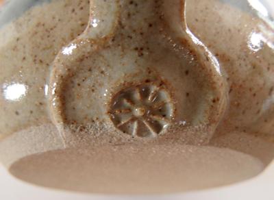 This is the mark at base of handle - Nine-spoked wheel or a sunburst on Studio Pottery Mug