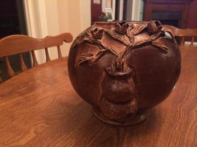 Old Round Brown pottery bowl with relief flower pots each side