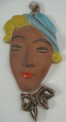 Terracotta Caribbean lady face wall plaque with pottery mark saying 'something... PORT'