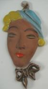 Terracotta Caribbean lady face wall plaque with pottery mark saying 'something... PORT'